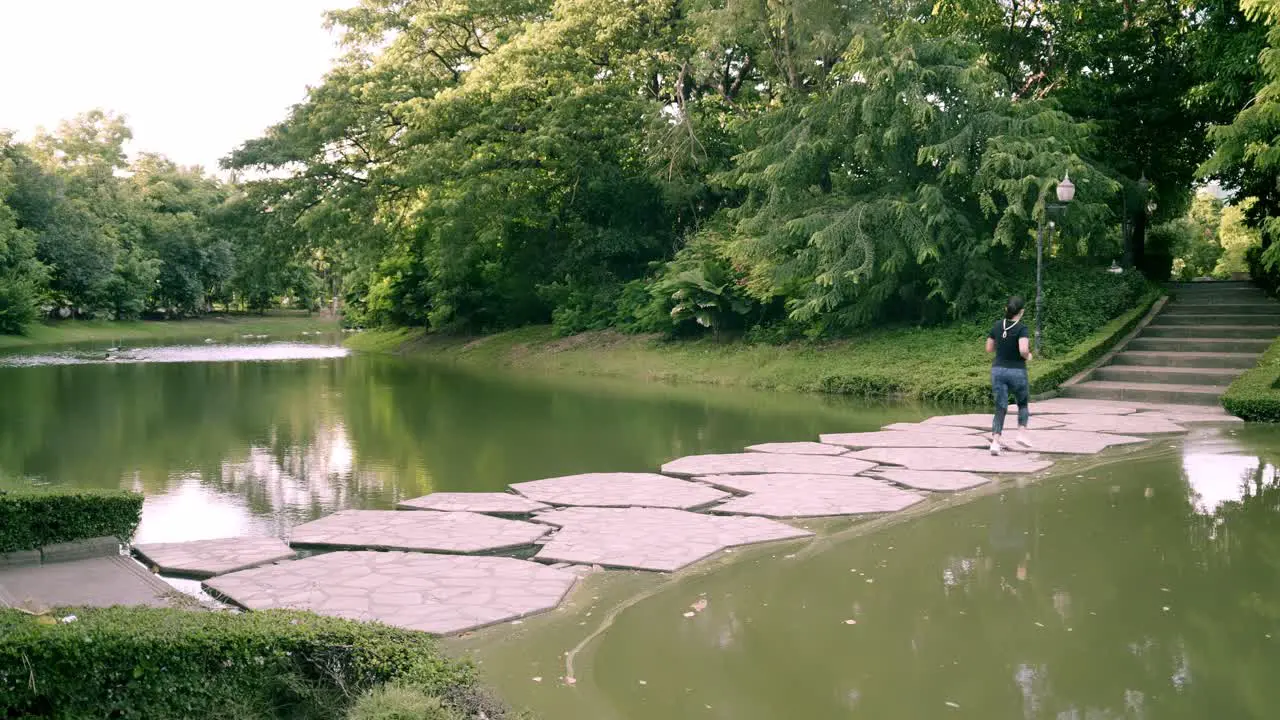 Follow up the scene of New normal young Asian women are exercising with outdoor running in the park