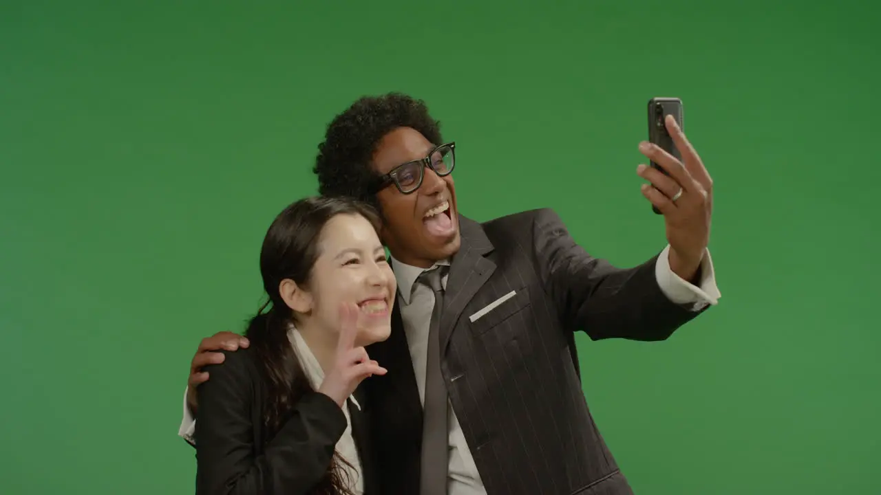 Smiling Colleagues Taking Seflie on Green Screen