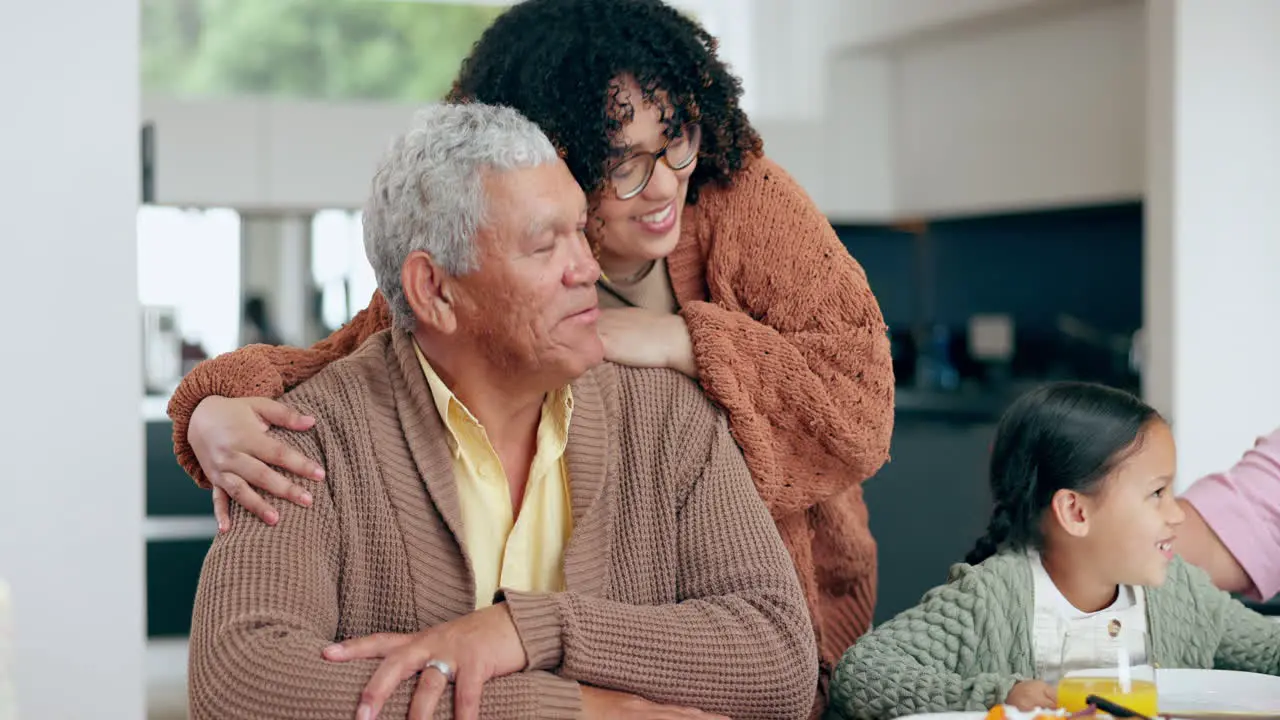 Woman hug senior father and dinner table