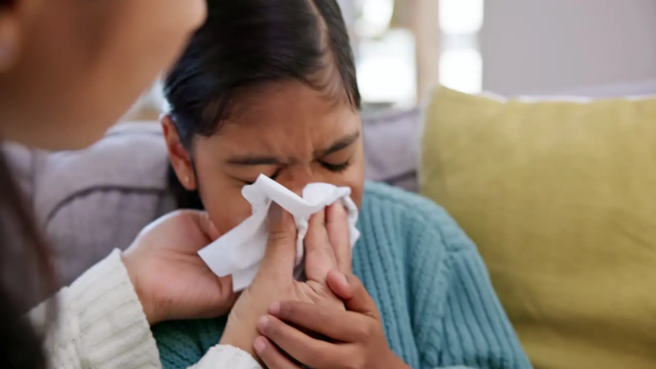 Sick young child and tissue with blowing nose