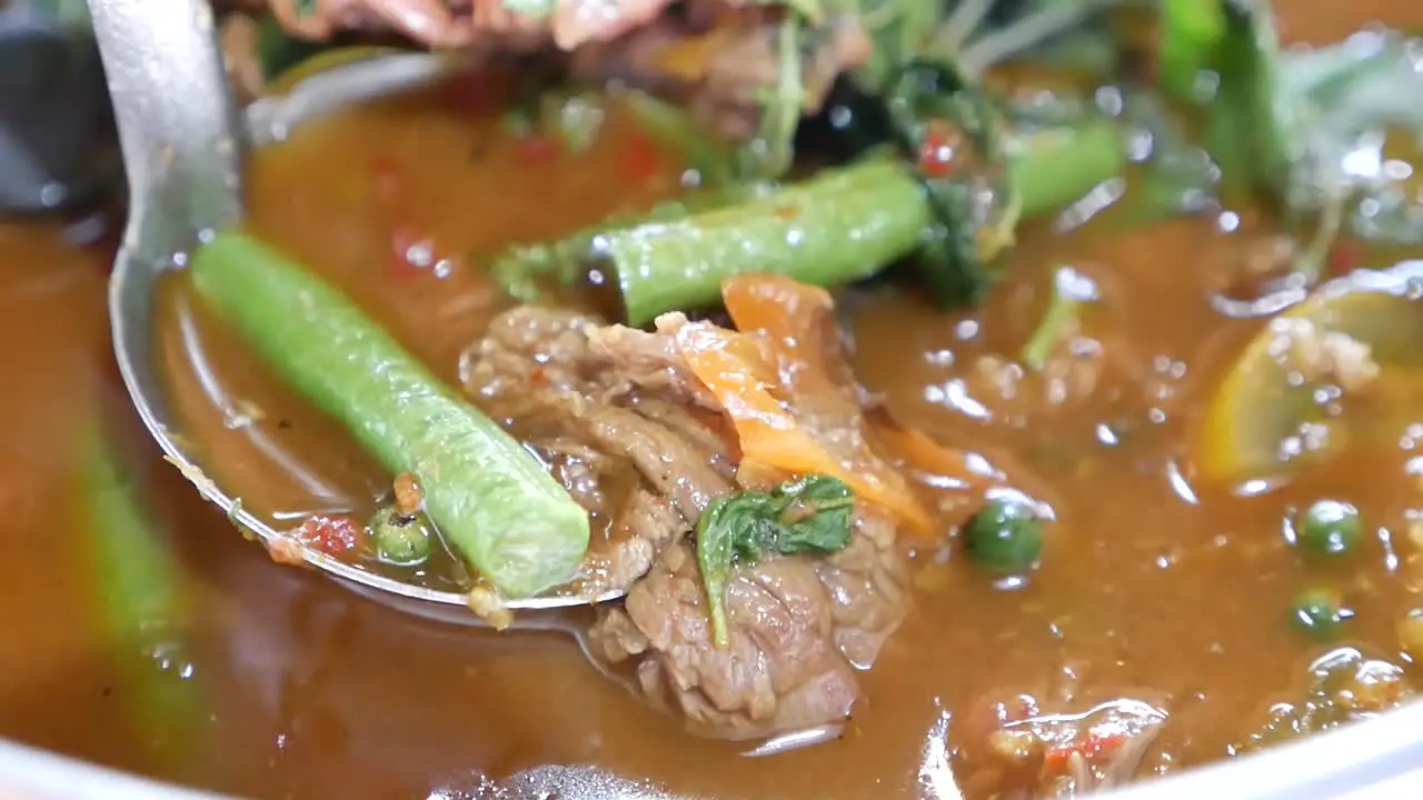 Close Up Footage of Hot and Spicy Beef Clear Soup Curry With Long Curd Beans and Holy Basil Leaves One of the Delicious Homemade Dish In Thailand