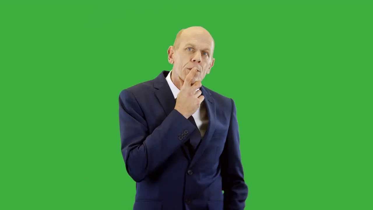 A pensive businessman deep in thought thinking of a solution to a business problem with green screen background