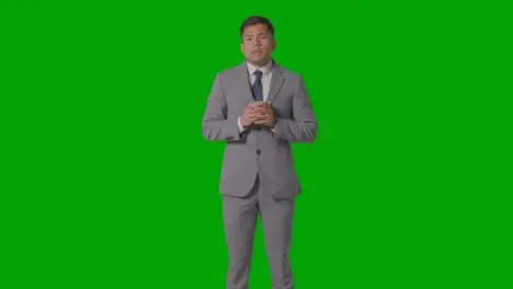 Studio Shot Of Businessman In Suit Holding And Drinking Cup Of Hot Drink Against Green Screen 1