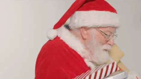 Close Up Shot of Santa Walking Into and Out of Frame Holding Presents