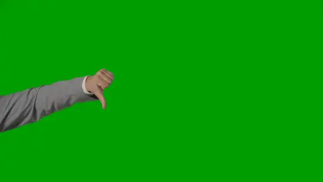 Close Up Of Arm Of Businessman In Suit Giving Thumbs Down Gesture Against Green Screen 