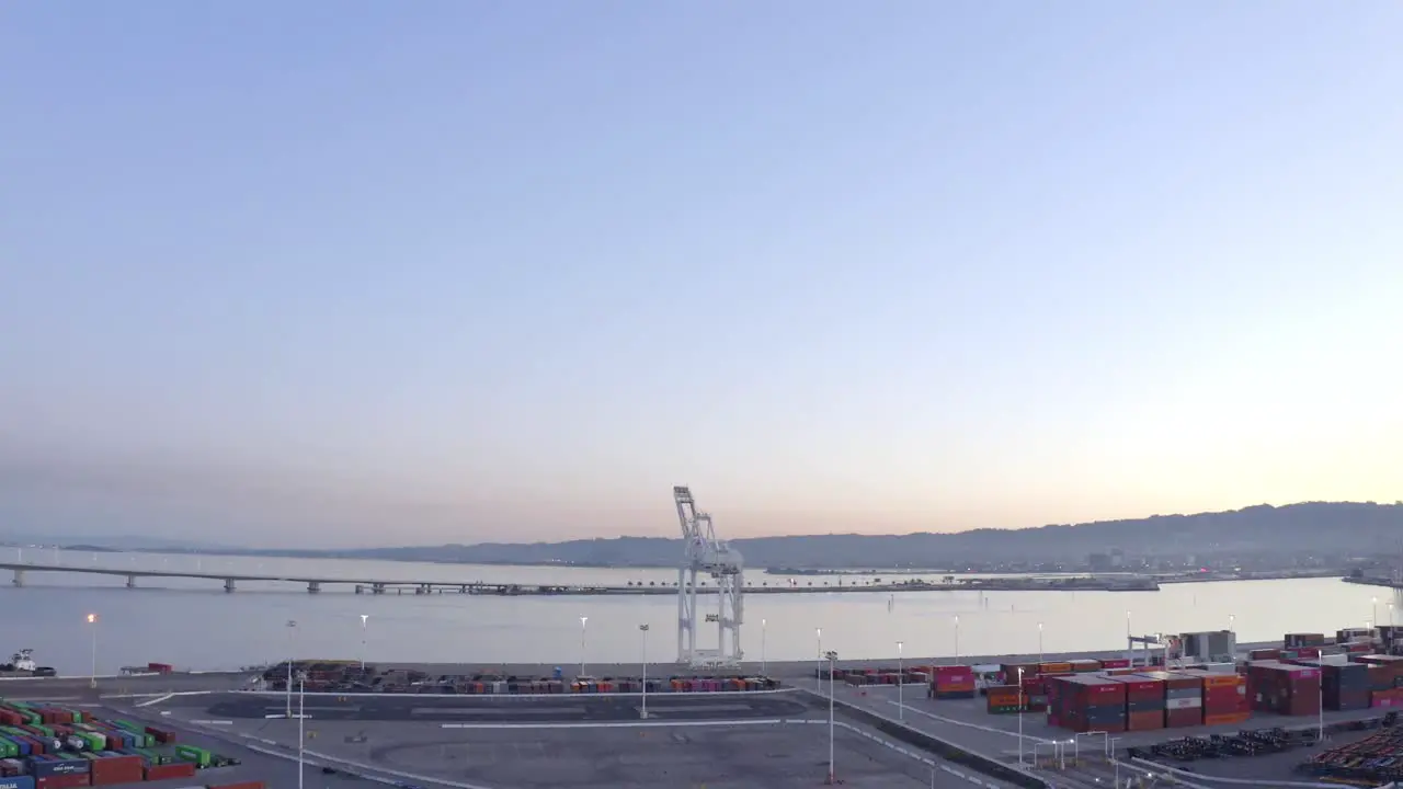 Slow rise to reveal a large shipping crane in the port