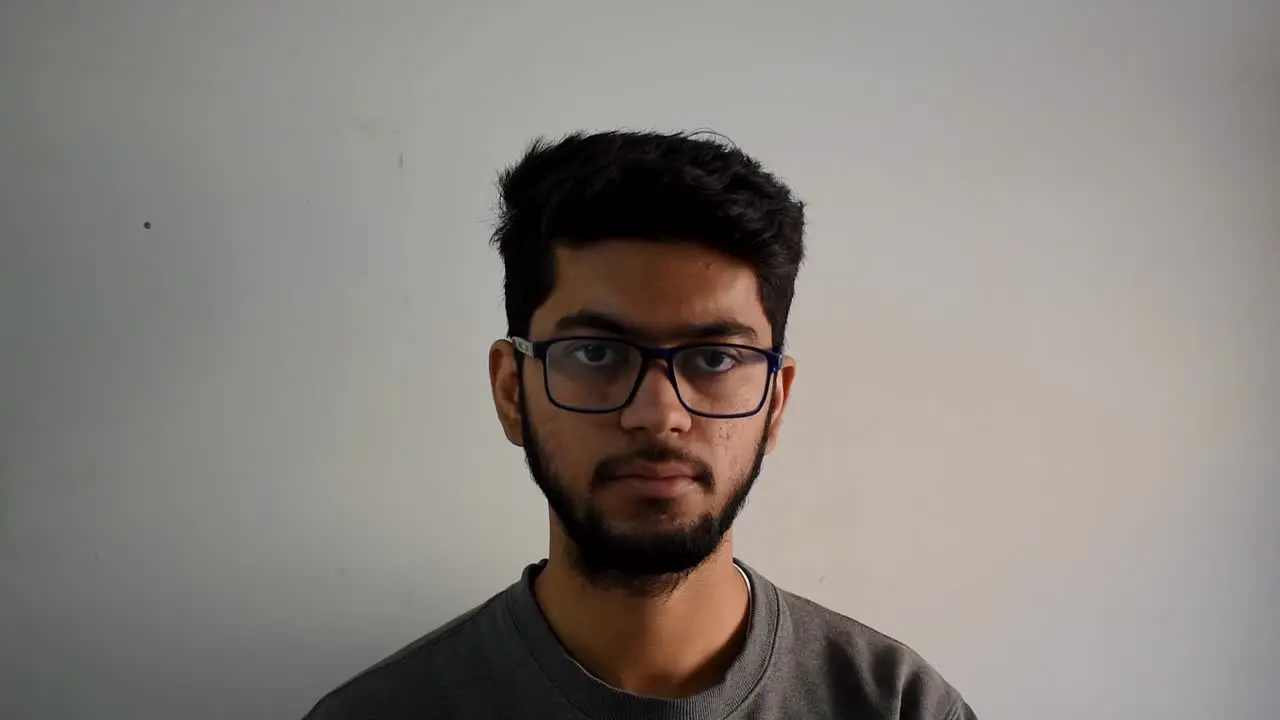 portrait of serious young adult man looking at camera in the office close up confident expression young man