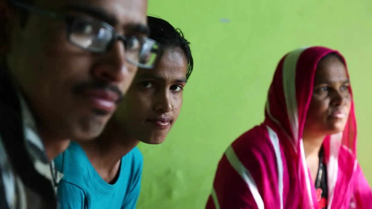 Indian man with glasses and family looking at camera Rajasthan