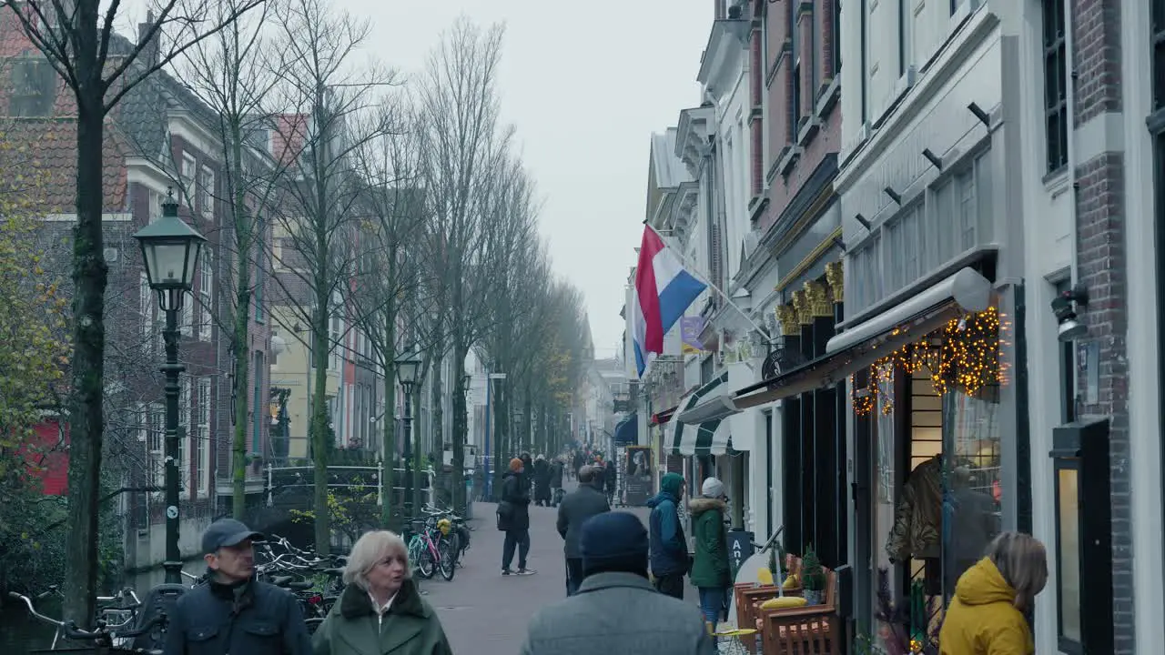 Slowmotion shot of people walking alongside the small canals looking in shops in Rotterdam