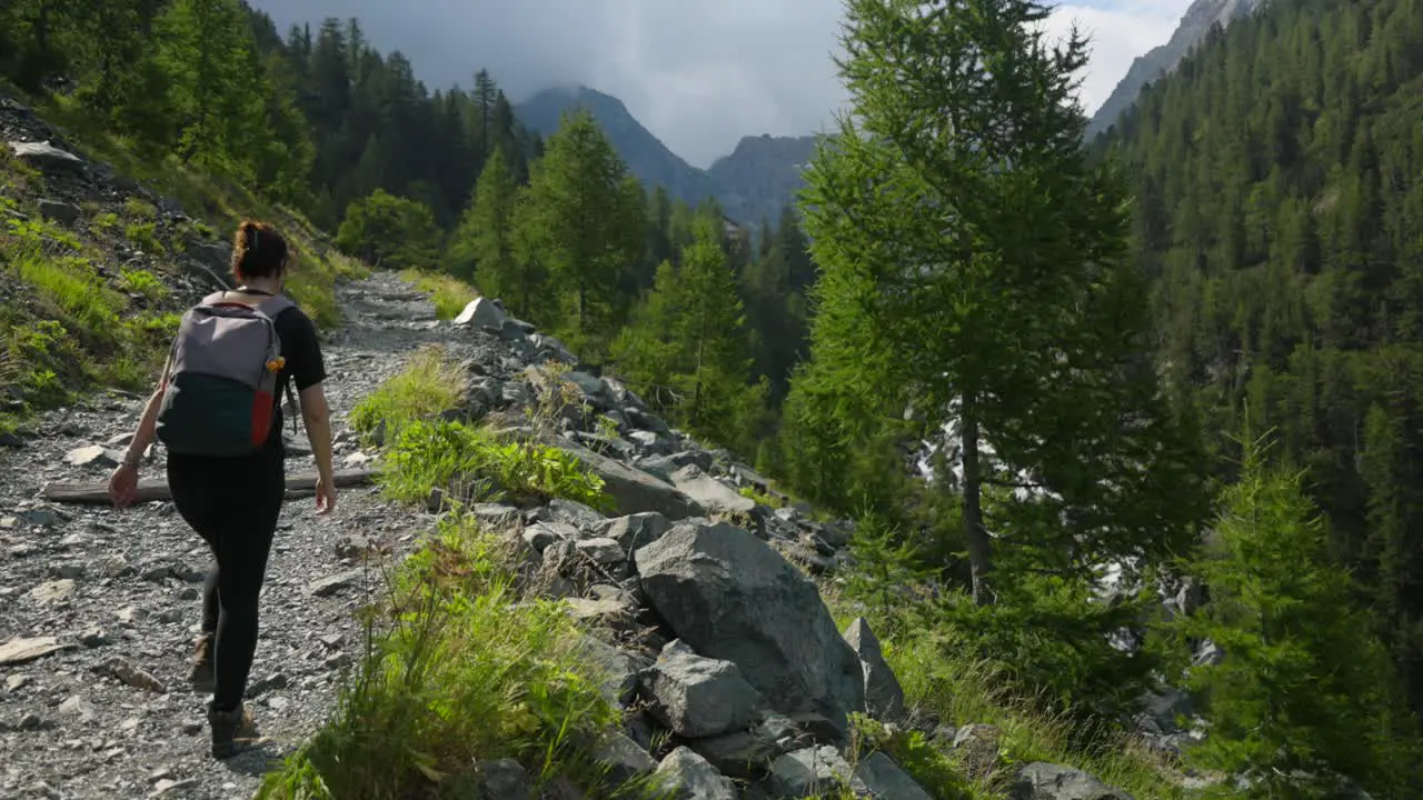 Woman trekking in Val Ventina of Valtellina in northern Italy