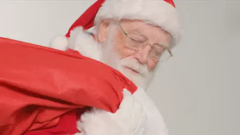 Close Up Shot of Santa Walking Into and Out of Frame Holding Sack of Presents