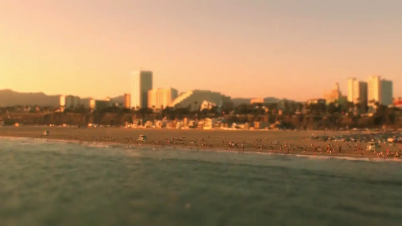 A beautiful off-shore shot of the famous Santa Monica Beach with many beach goers enjoying the summer