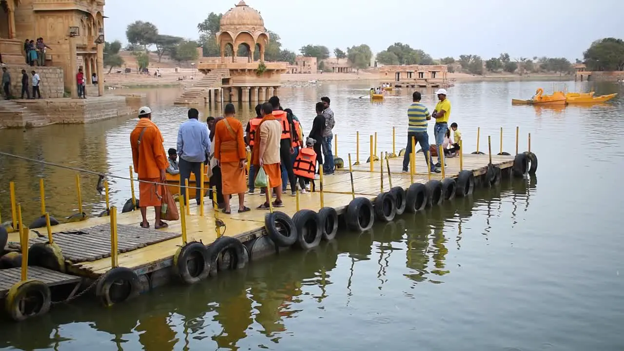 Bunch of tourist standing on the platform waiting for their turn to boat