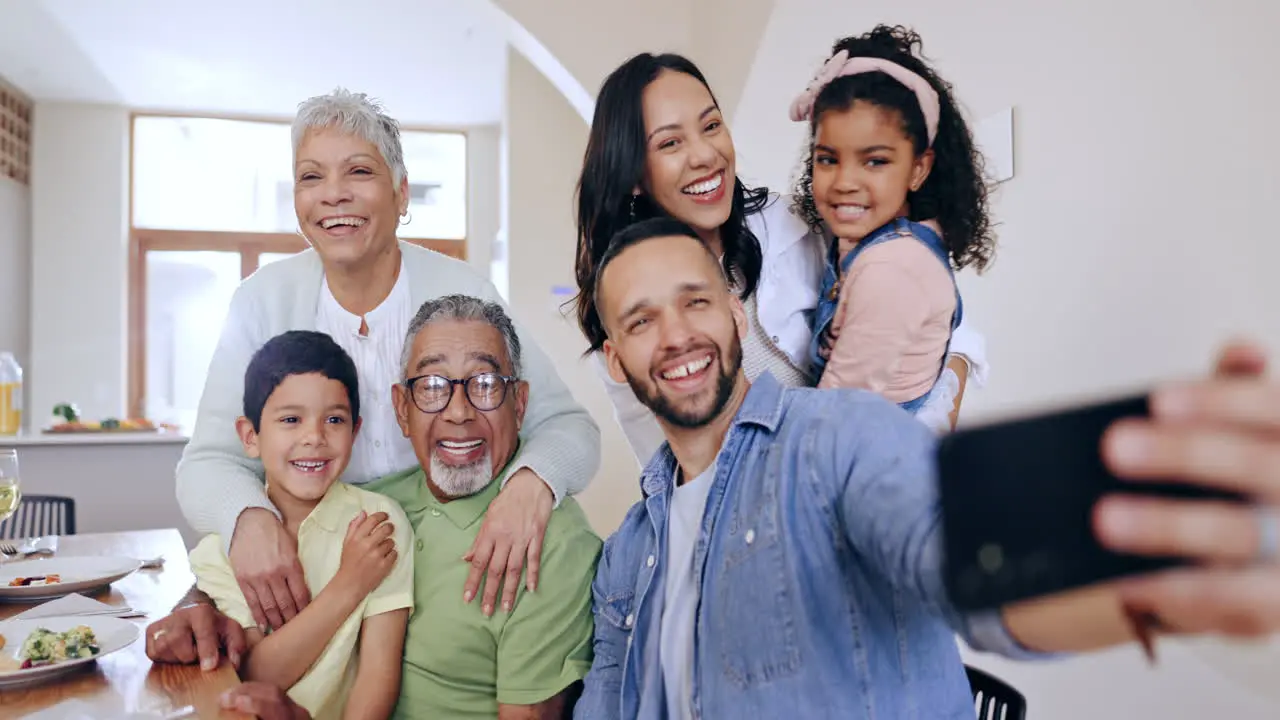 Happy family hug and selfie by dinner table