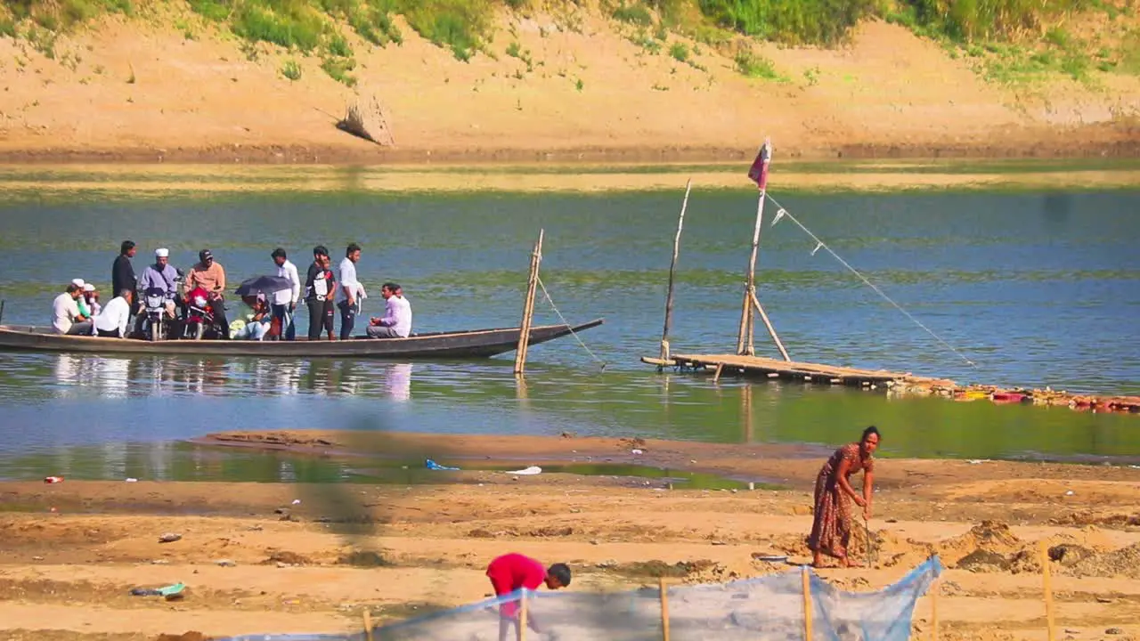 Traditional wooden Bangladesh ferry boat in Surma river handheld