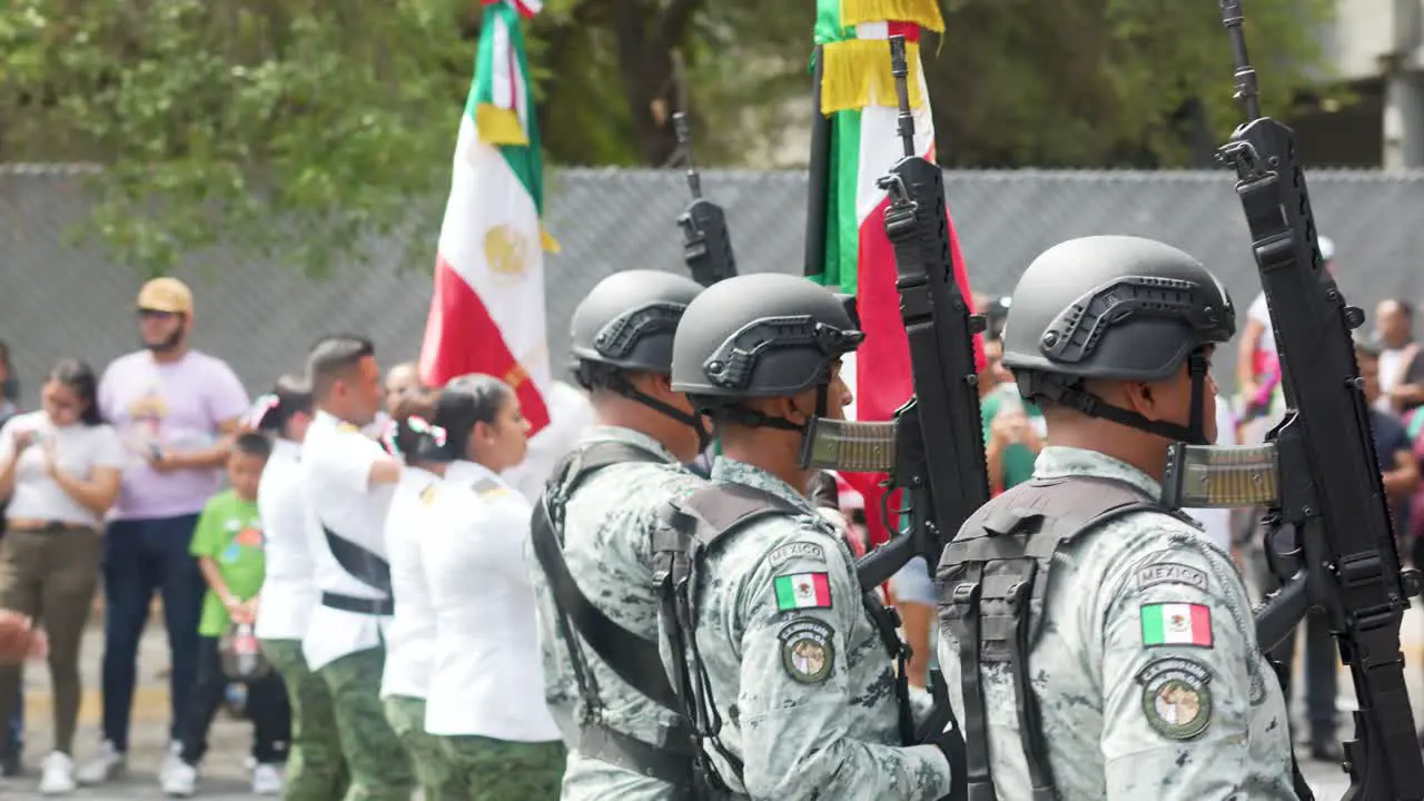 Soldiers with mexican flag at the parade in honor of Independence Day of Mexico