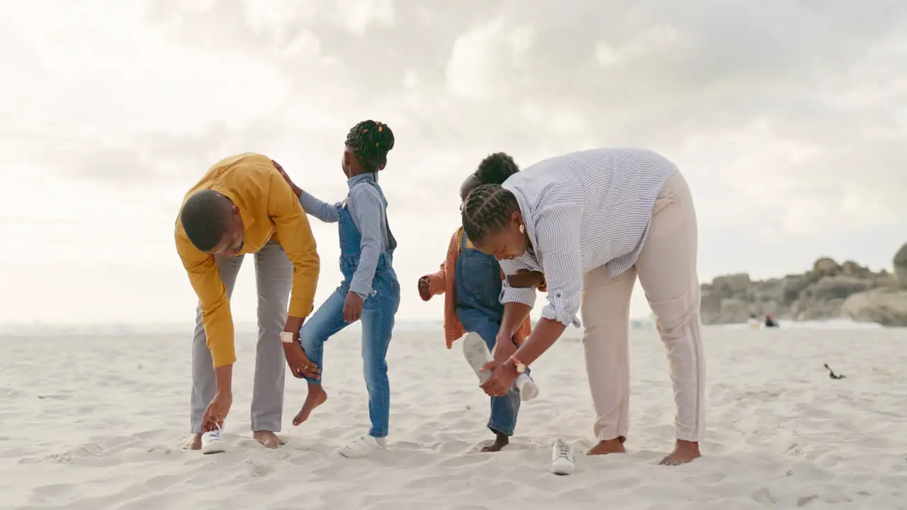 Summer sand and a black family at the beach