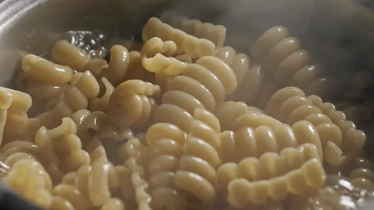 Close up of large saucepan of Radiatore pasta cooking