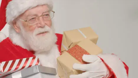 Close Up Shot of Santa Walking Into and Out of Frame Holding Gifts