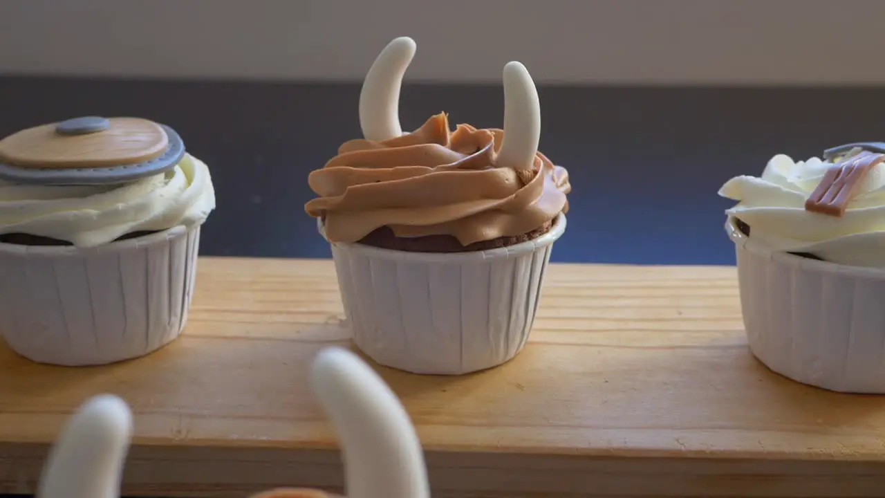 Dolly out flyover Cupcakes display on table with Viking theme decoration Slow motion