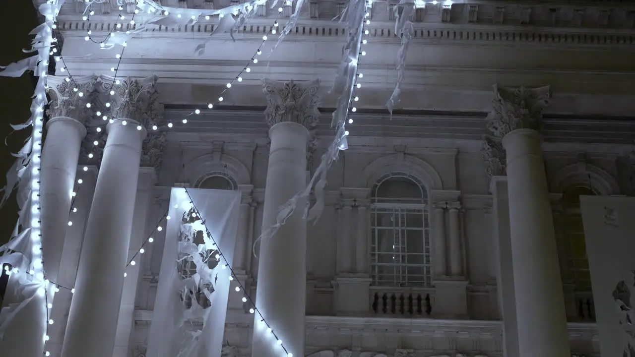 Close up detail shot of strands of Christmas lights holiday decorations hung on the facade of the Tate Britain museum