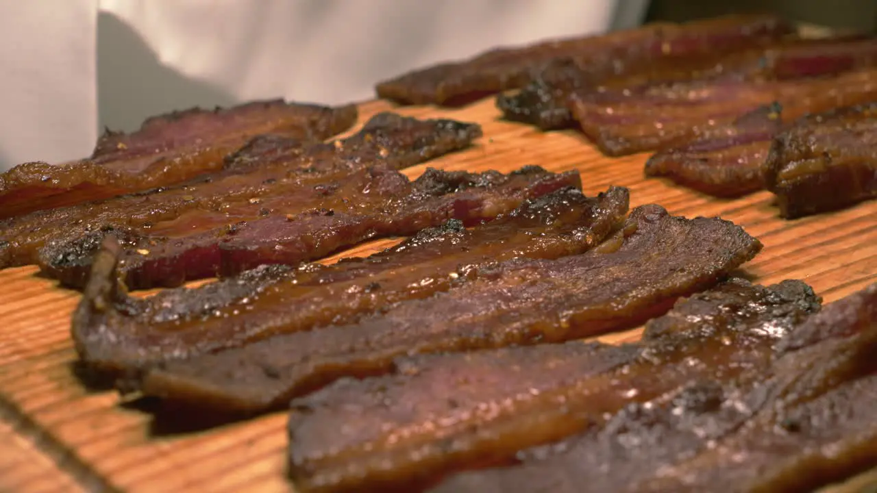 Beef strips placed under heater at Brazilian restaurant