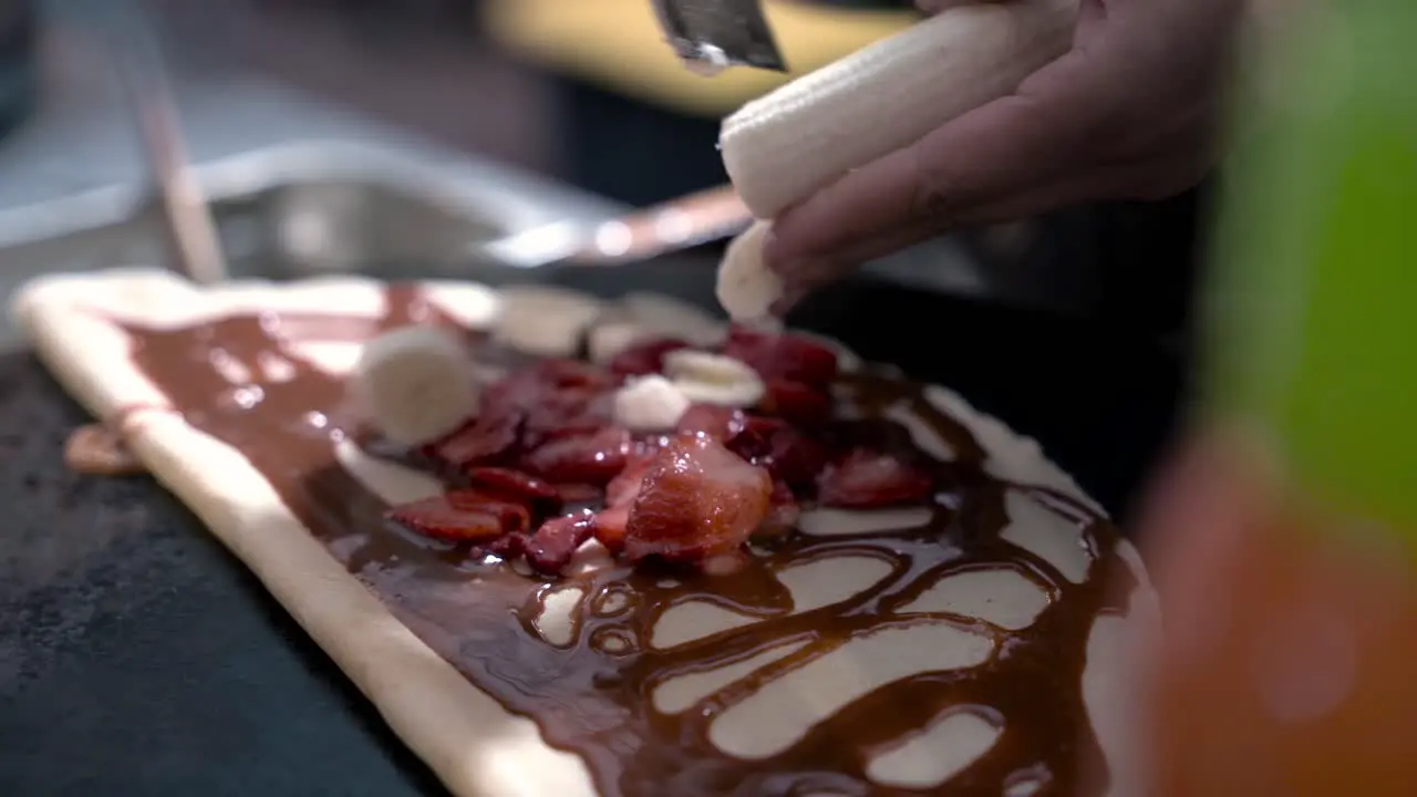 Adding banana on to the crepe