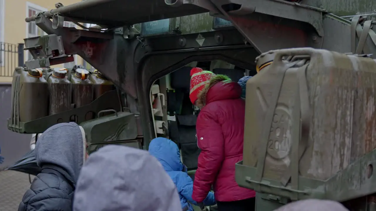 People looking inside of armored vehicle in Latvia Riga