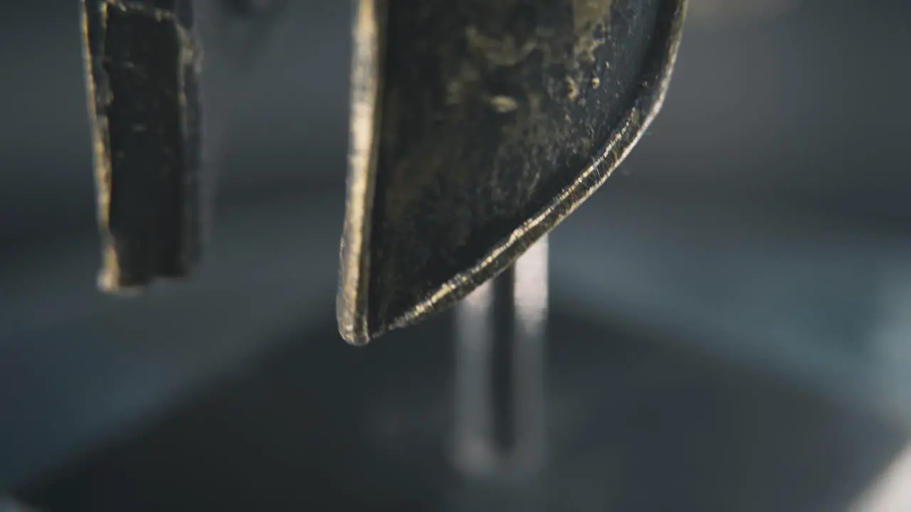 A close up macro spiral slow tilt up shot of a spartan face design warrior ancient greek bronze helmet on a 360 rotating stand studio lighting 4K smooth movement