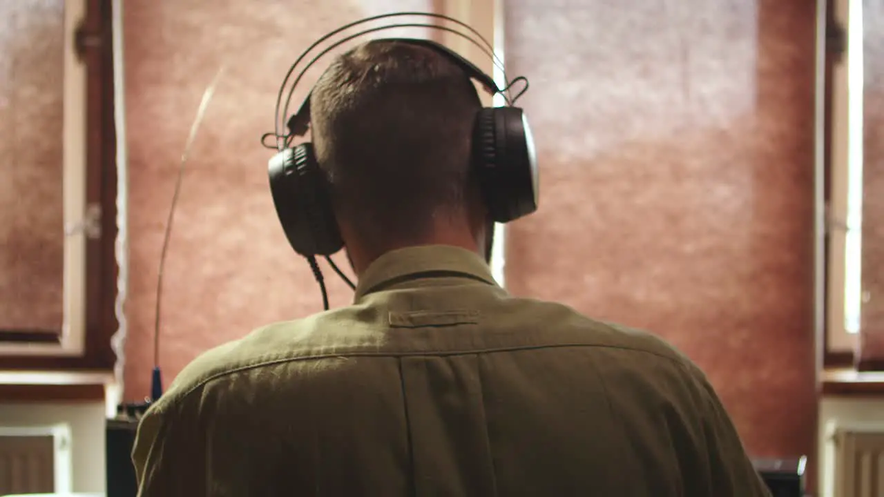 Military radio operator using headphones before speech back view of head