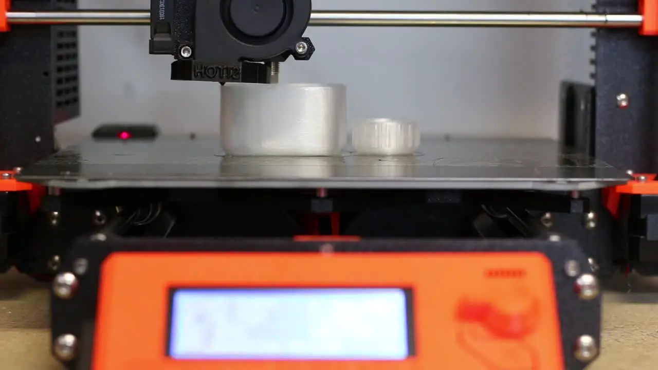 Brand new Prusa 3D Printer uses recyclable filament to print a small water bottle and lid