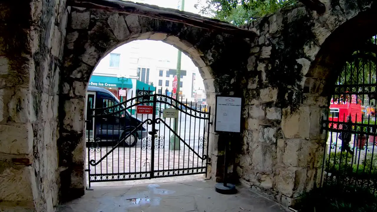 Stone Walls line The Alamo grounds where visitors can learn of the deeds of Davy Crockett and William Travis during the 13 days of the siege and battle for Independence 4K30fps Seg 1 of 2 Slow Motion