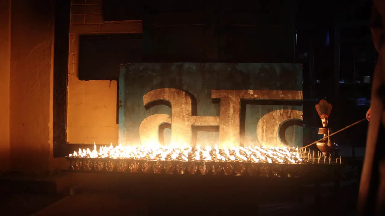 Religious candlelight flames burning in Nepal at night