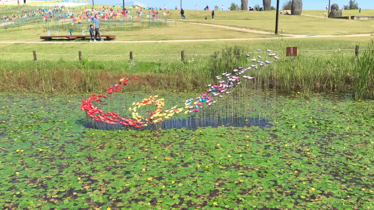 A mother and a son walk by a pond at Imjingak by the DMZ overlooking North Korea in Munsan Paju Gyeonggi-do South Korea