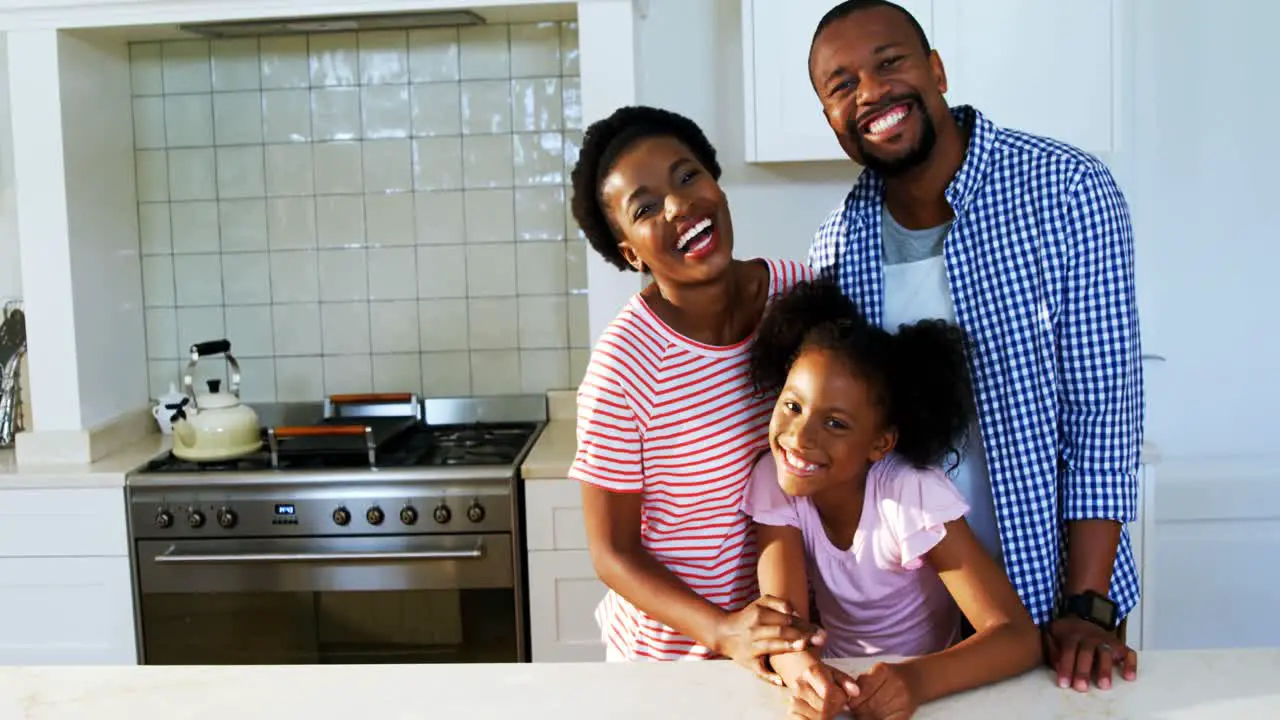 Portrait of parents and daughter in kitchen