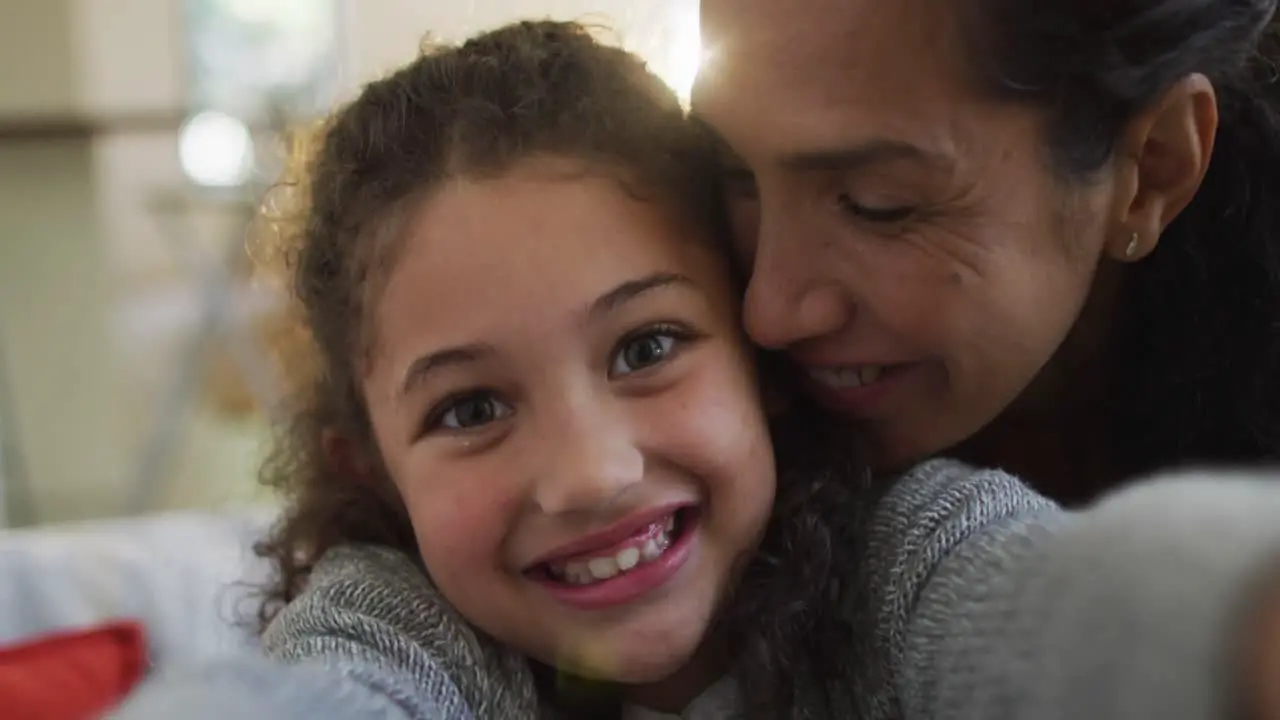 Portrait of happy mixed race mother and daughter