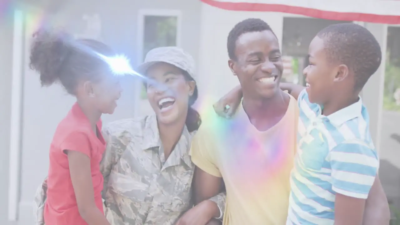 Animation of lights over happy african american soldier mother hugging kids and husband