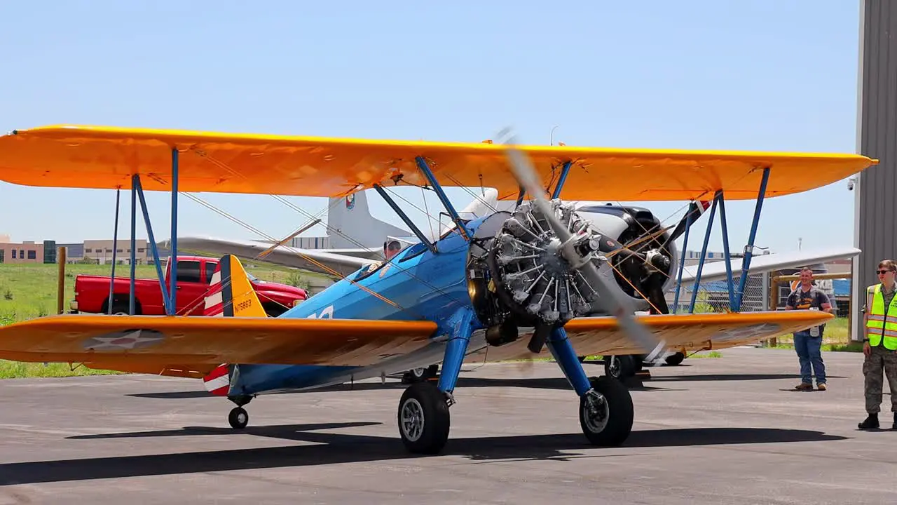 Boeing Stearman Model 75 vintage world war II training aircraft starting up at an airshow at the Centennial Airport in Colorado