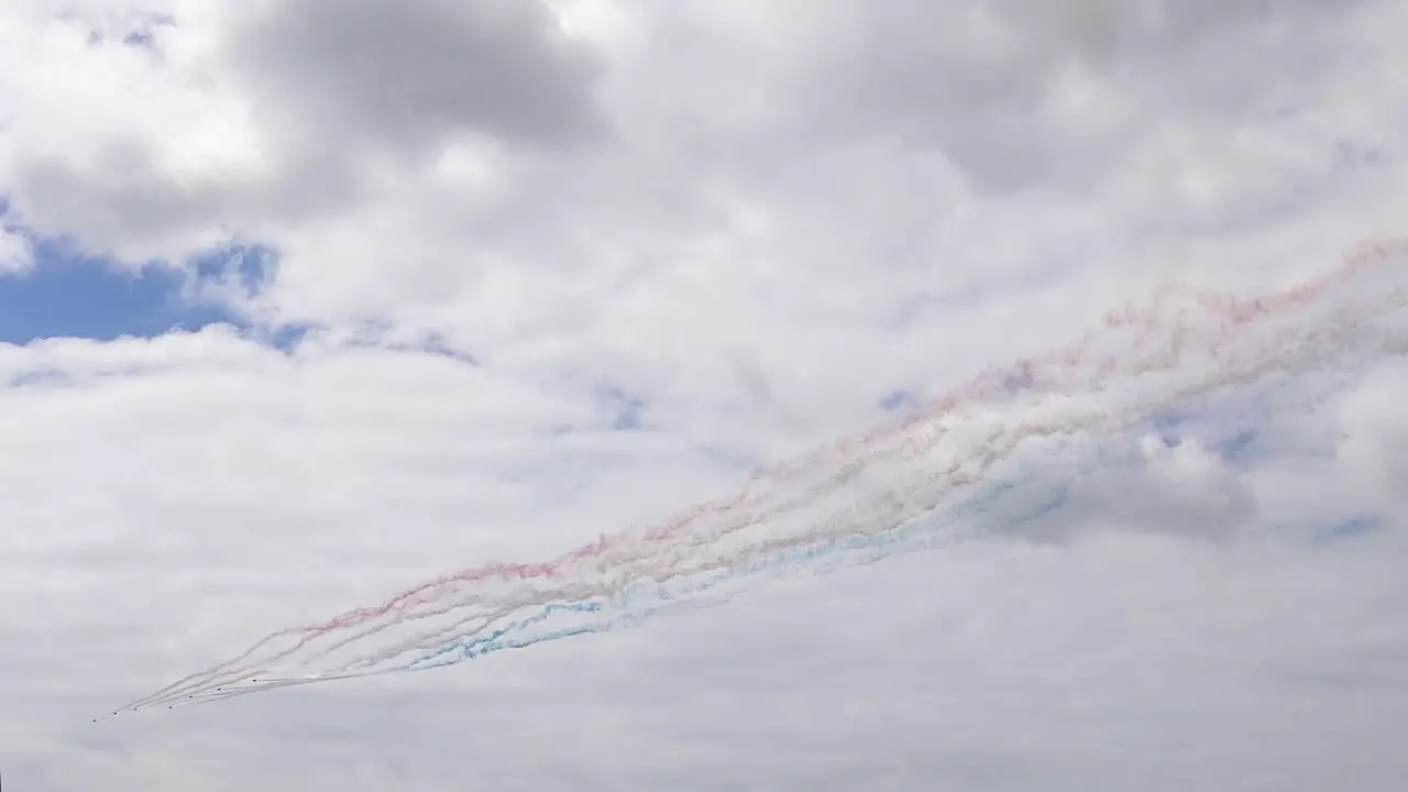 Red Arrows Flying in Formation Trailing Blue and Red Smoke During Swansea Bay Air Show