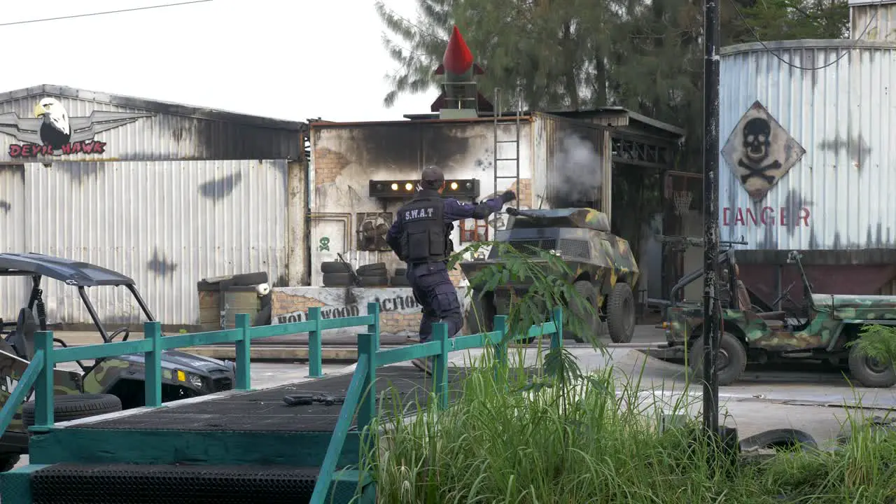 SWAT Actor throwing a grenade to a tank as tank fires a shot on industrial terrain Dream World