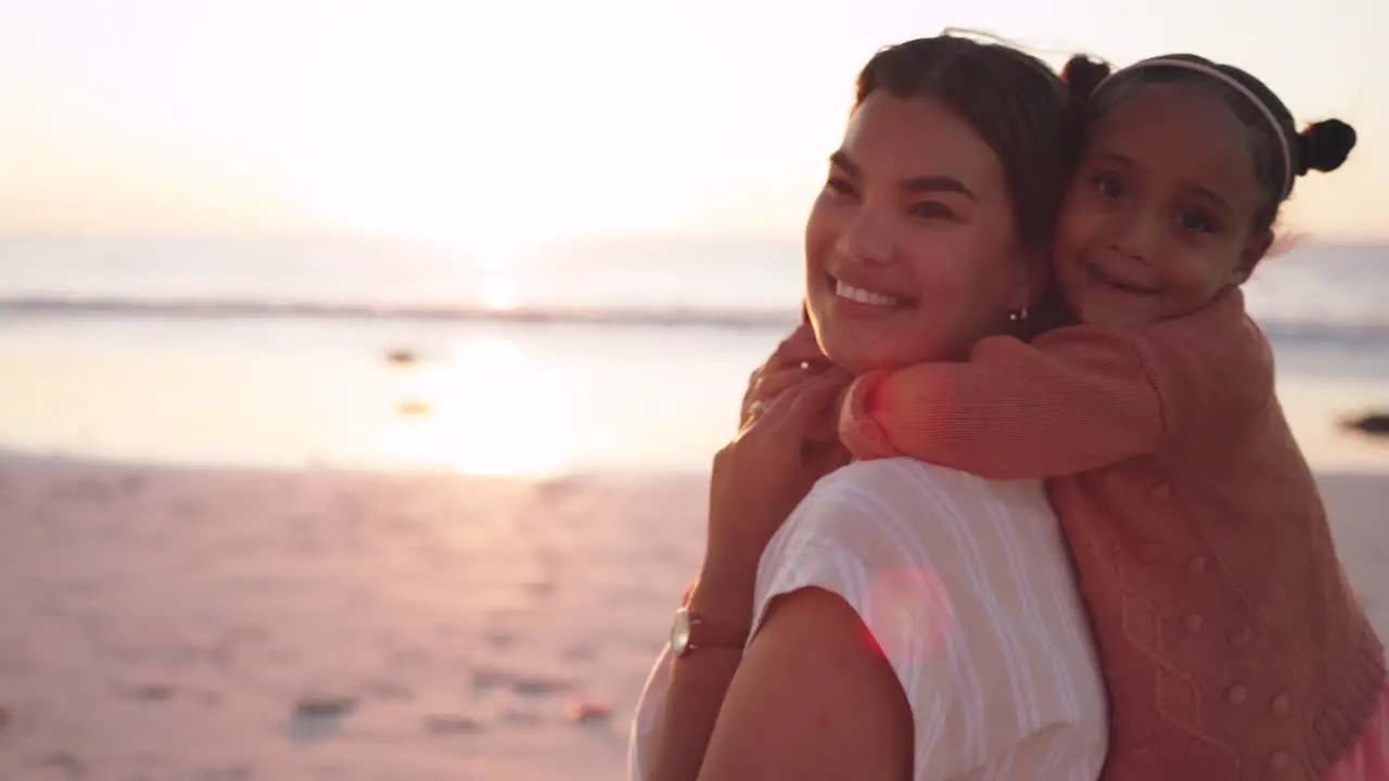 Child mom and piggy back on beach on playful