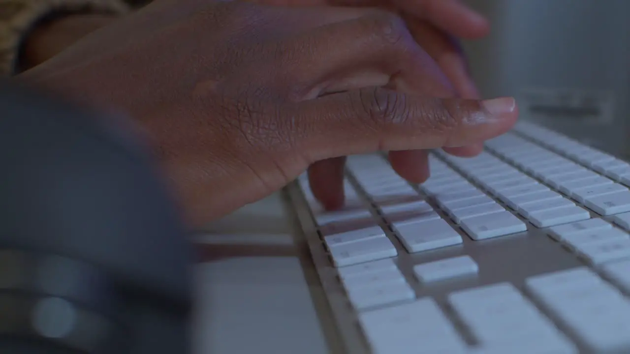 Developer fingers typing on mac keyboard with mouse on the right medium shot