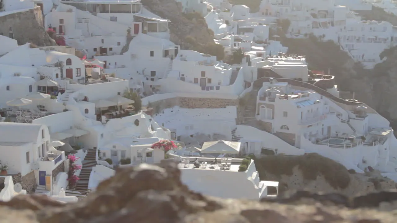 View from above of holiday villas and rooms in the traditional cycladic greek village of Oia Santorini