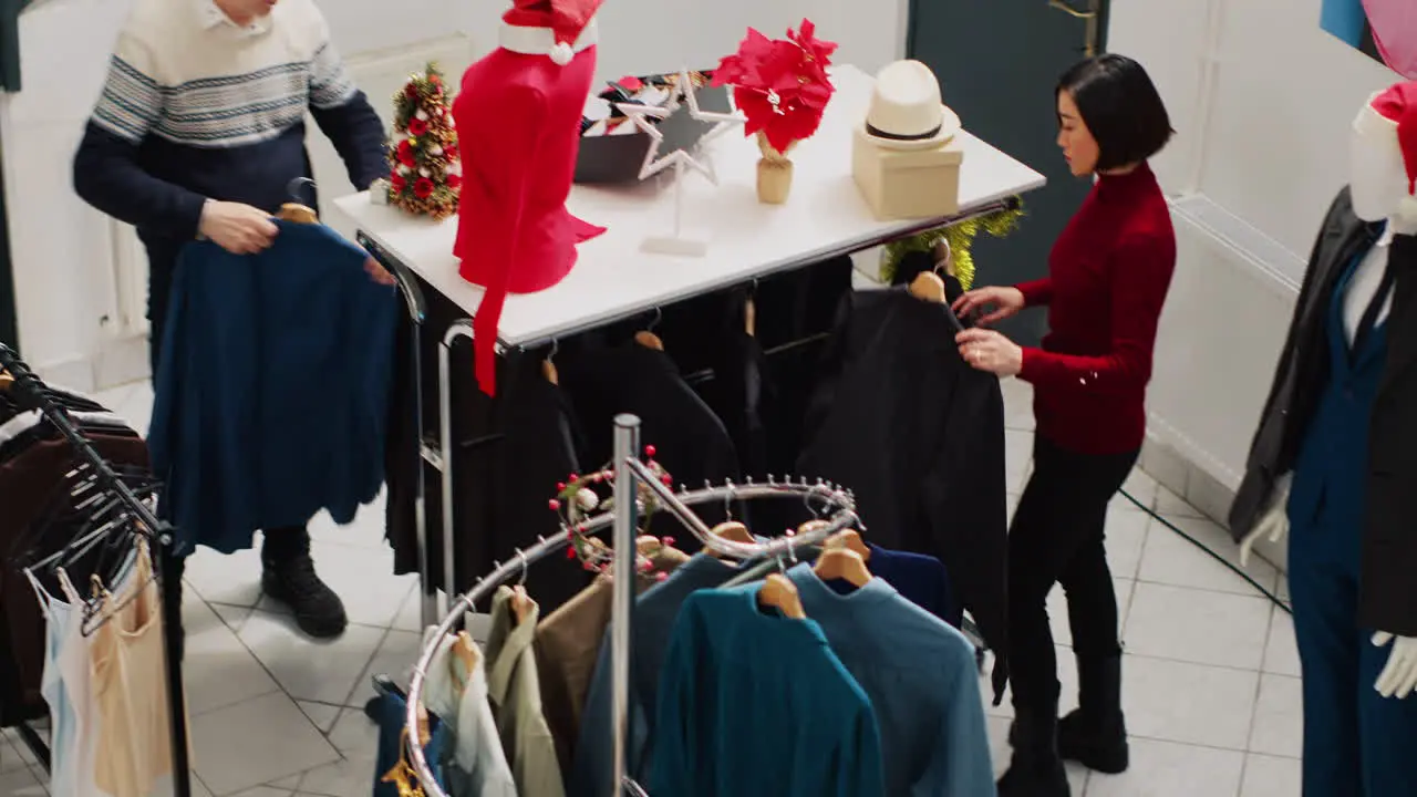 Busy clothing shop filled with customers in Christmas frenzy looking to buy perfect gifts for friends and family Clients in shopping spree at mall boutique during winter holiday season