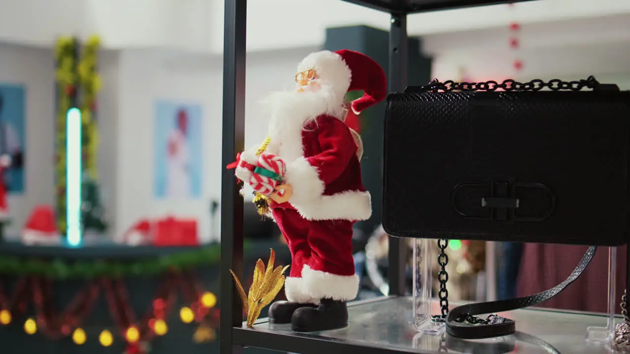 Extreme close up shot of miniature Santa Claus toy used as Christmas ornament in empty festive adorn fashion shop during winter holiday season Xmas decorations in shopping mall store