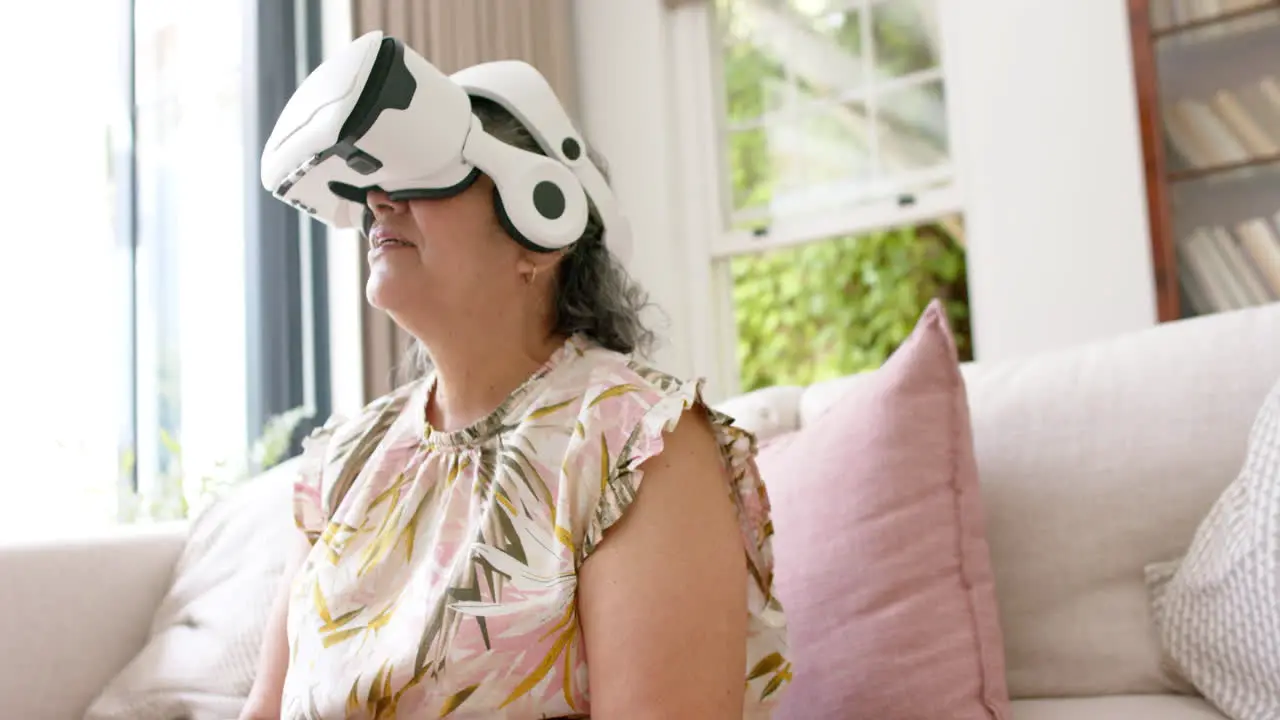 Senior Caucasian woman experiences virtual reality at home