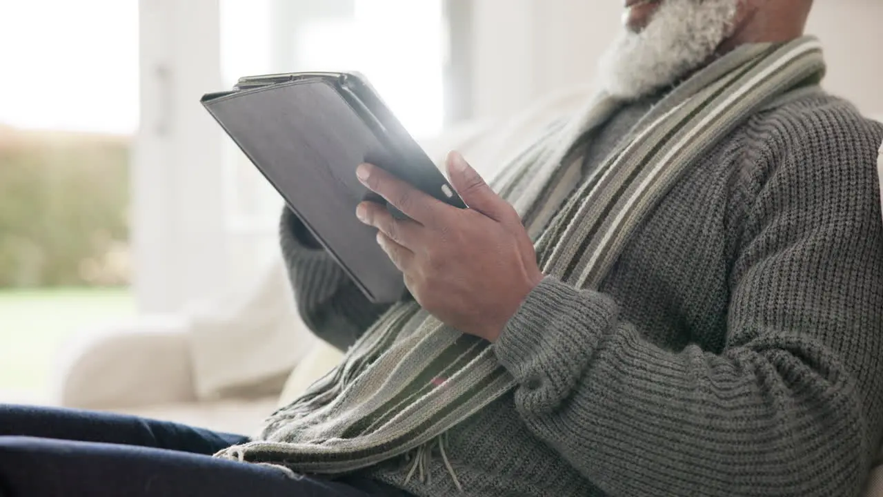 Mature man and tablet scroll in home closeup