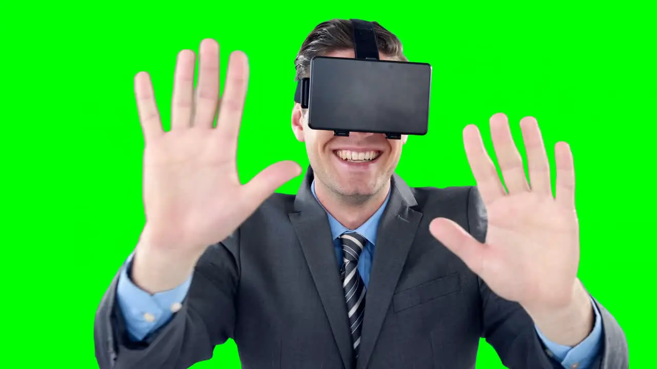 Happy businessman using virtual reality headset