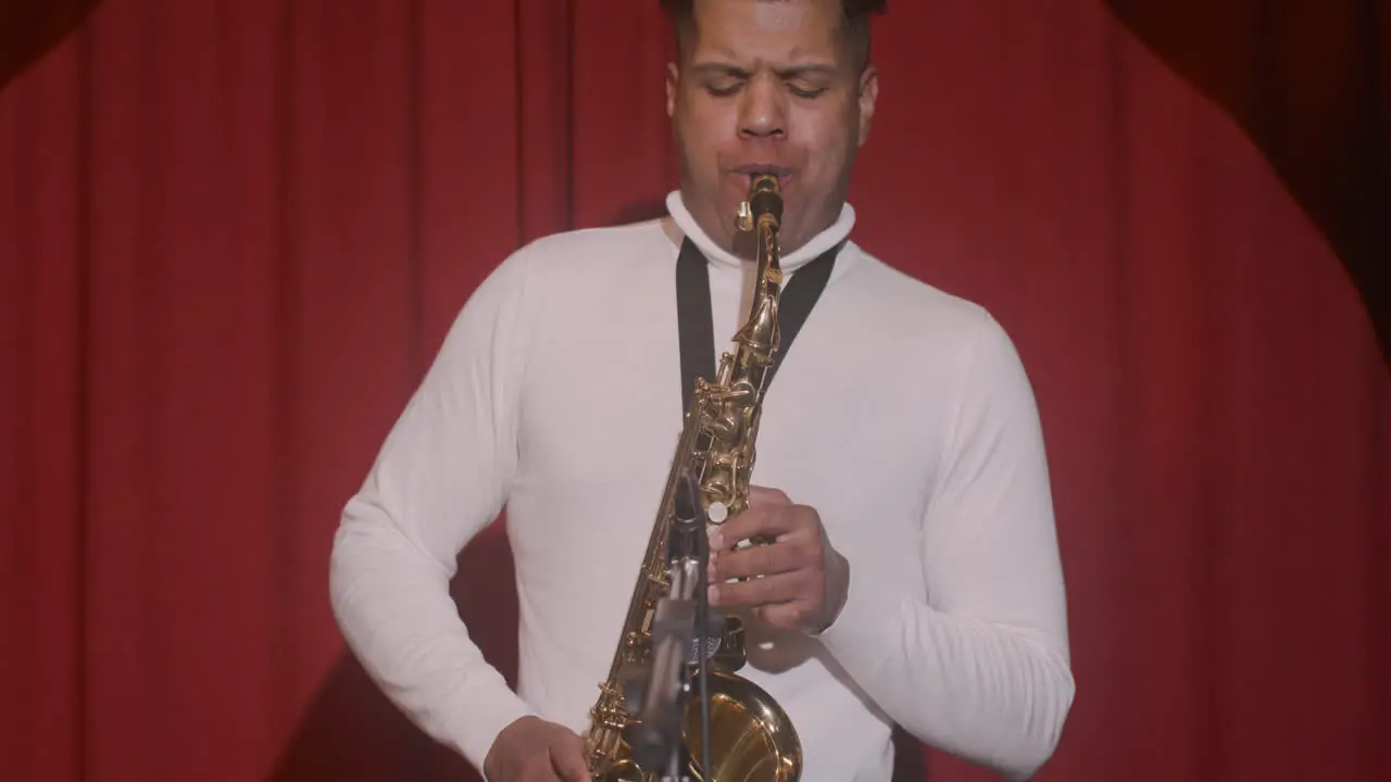 Front View Of Latin Man Playing Sax During Live Music Perfomance