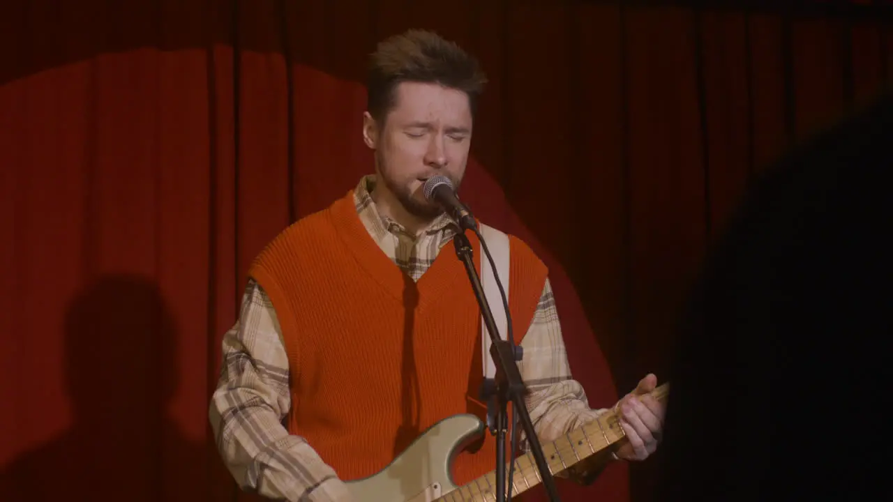 Male Musician Playing Guitar And Singing During Live Music Perfomance 5